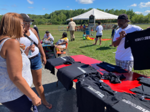 两个黑人看着一个黑人在卖《坚强》。保持黑色。的t恤